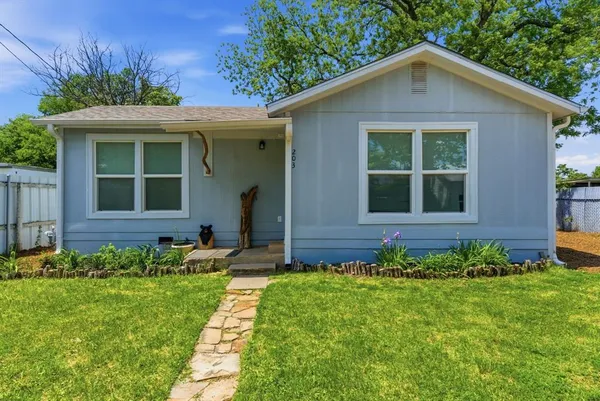 a front view of a house with a garden