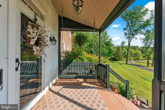 a dining room with furniture floor a rug a potted plant and a chandelier