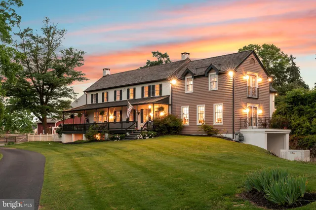 a view of a big building with big yard and large trees