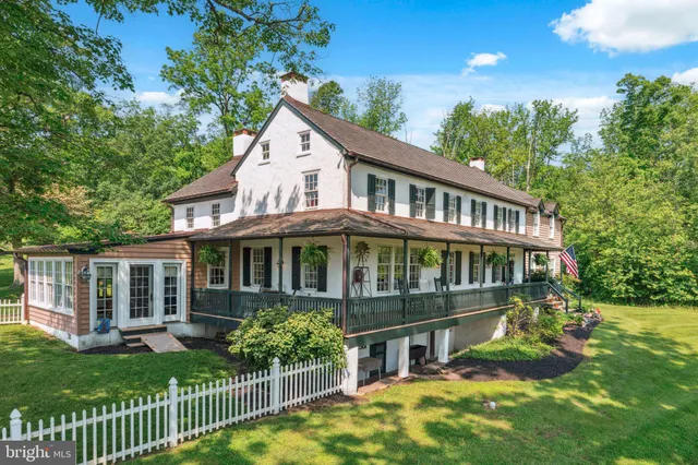 a view of a house with a yard and potted plants