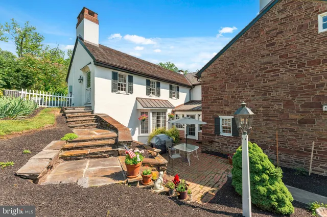 a view of a table and chairs in the garden