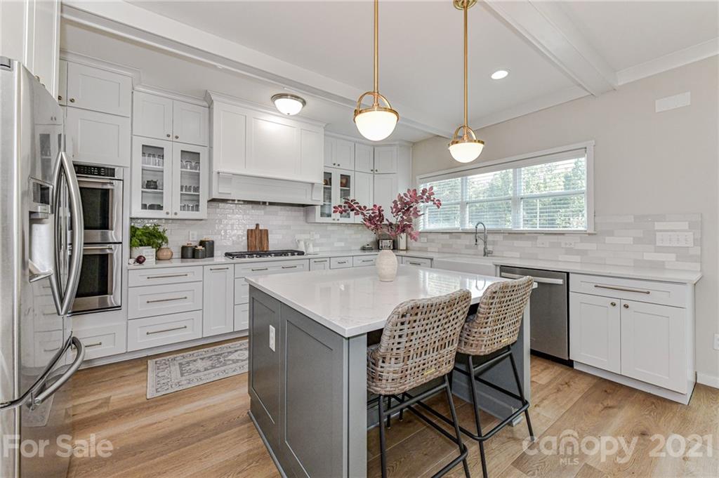 8074 Bryson Road Indian Land, SC 29707 - Photo 17 of 46 a kitchen with white cabinets and stainless steel appliances