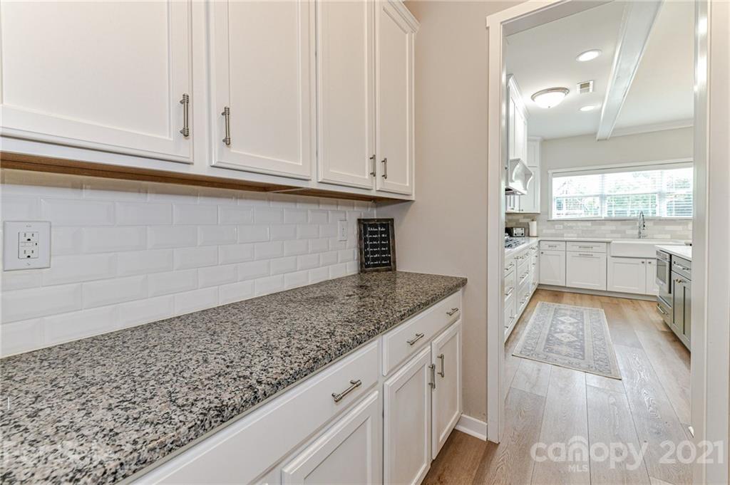 8074 Bryson Road Indian Land, SC 29707 - Photo 22 of 46 a kitchen with granite countertop white cabinets and white appliances