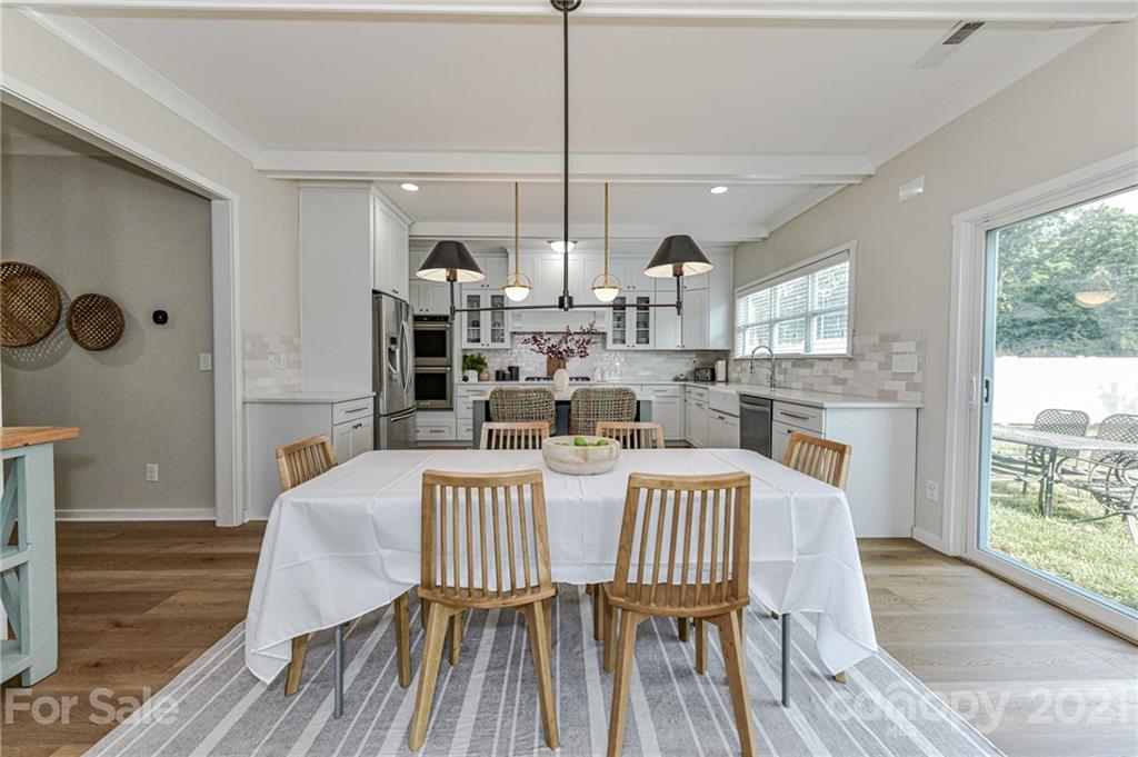 8074 Bryson Road Indian Land, SC 29707 - Photo 24 of 46 a view of a dining room with furniture and wooden floor