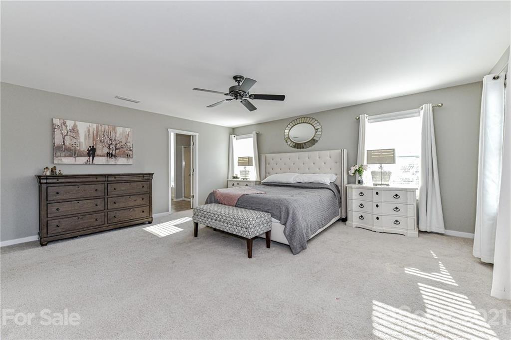 8074 Bryson Road Indian Land, SC 29707 - Photo 30 of 46 a spacious bedroom with a bed and a window