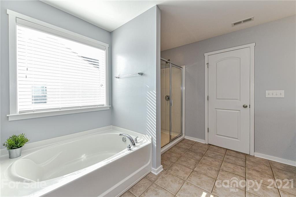 8074 Bryson Road Indian Land, SC 29707 - Photo 32 of 46 a bathroom with a bathtub and shower