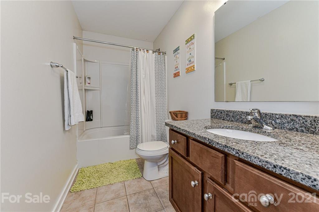 8074 Bryson Road Indian Land, SC 29707 - Photo 35 of 46 a bathroom with a granite countertop sink toilet and shower
