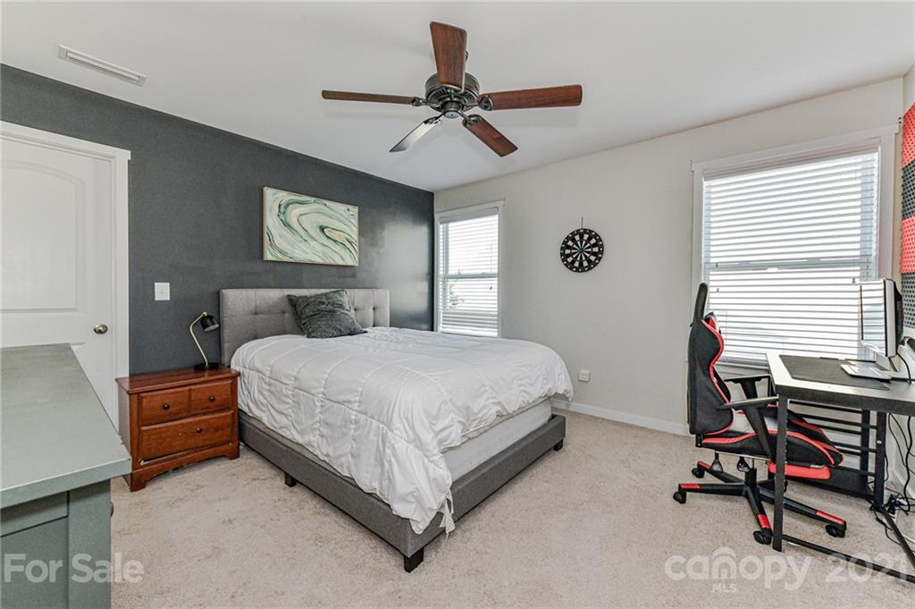 8074 Bryson Road Indian Land, SC 29707 - Photo 36 of 46 a bedroom with a bed and a desk