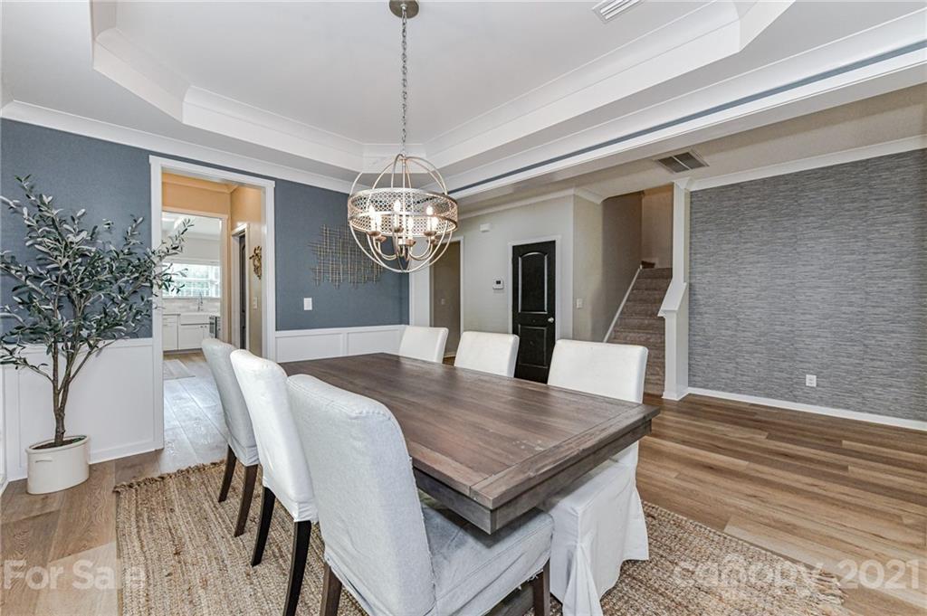 8074 Bryson Road Indian Land, SC 29707 - Photo 10 of 46 a view of a dining room with furniture and chandelier