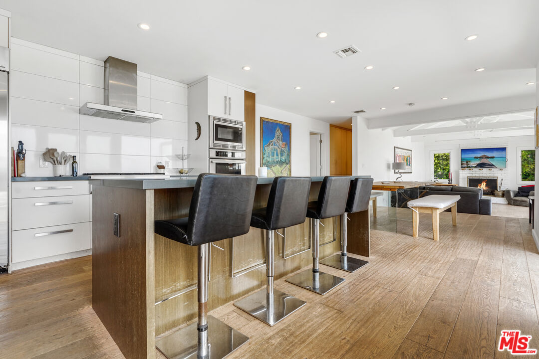 27861 Winding Way Malibu, CA 90265 - Photo 11 of 36 a large kitchen with a table and chairs