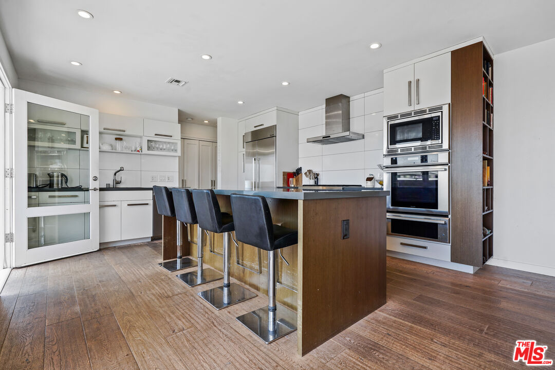 27861 Winding Way Malibu, CA 90265 - Photo 12 of 36 a kitchen with stainless steel appliances granite countertop a stove top oven a sink dishwasher and a refrigerator