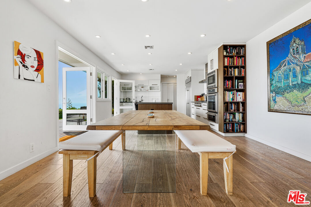 27861 Winding Way Malibu, CA 90265 - Photo 16 of 36 a living room with stainless steel appliances furniture a rug and a bookshelf