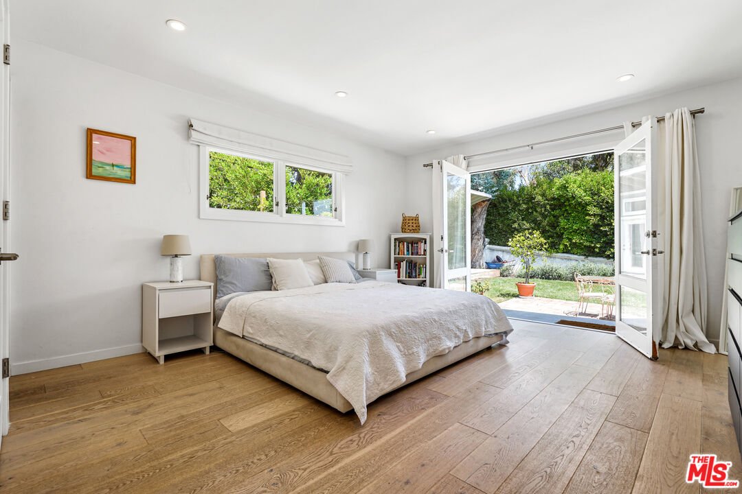 27861 Winding Way Malibu, CA 90265 - Photo 17 of 36 a bedroom with a large bed and a large window