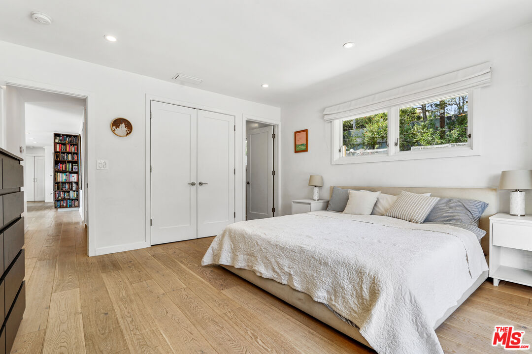 27861 Winding Way Malibu, CA 90265 - Photo 18 of 36 a spacious bedroom with a bed and a window
