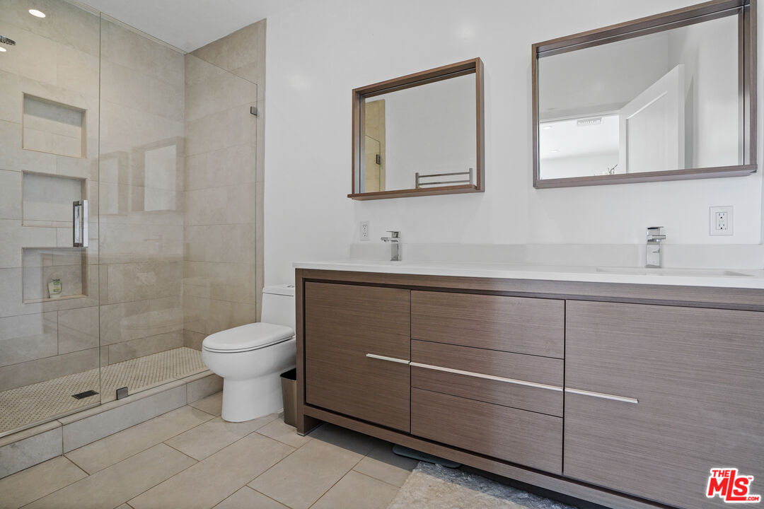 27861 Winding Way Malibu, CA 90265 - Photo 22 of 36 a bathroom with a toilet sink and mirror