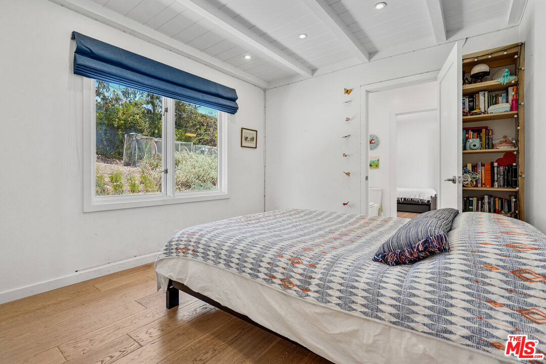 27861 Winding Way Malibu, CA 90265 - Photo 24 of 36 a bedroom with a bed and a large window