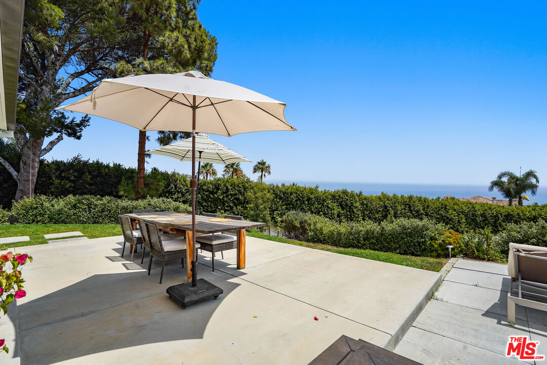27861 Winding Way Malibu, CA 90265 - Photo 29 of 36 an outdoor space with furniture and umbrella