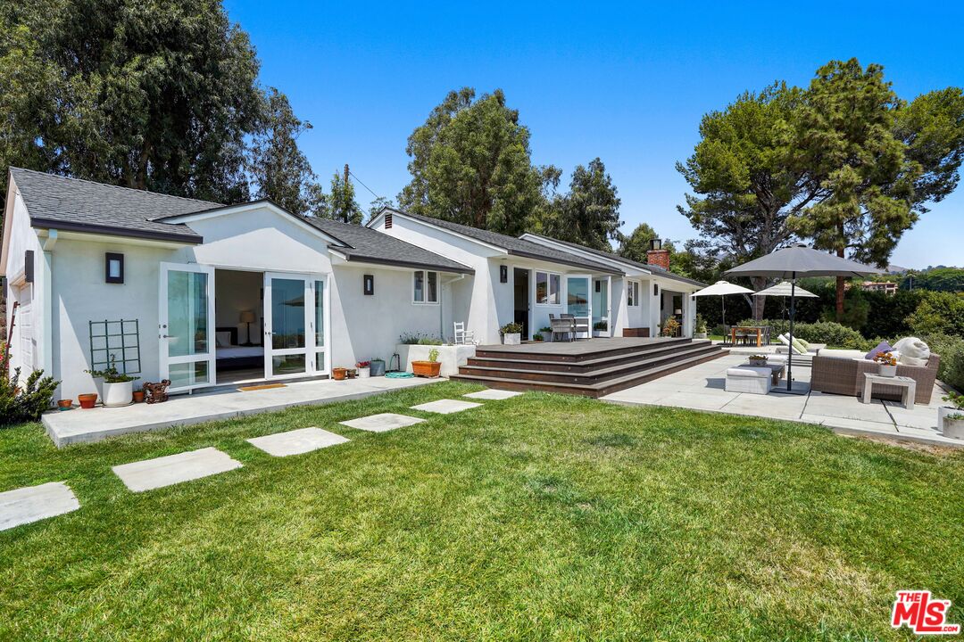 27861 Winding Way Malibu, CA 90265 - Photo 32 of 36 a front view of a house with swimming pool and porch