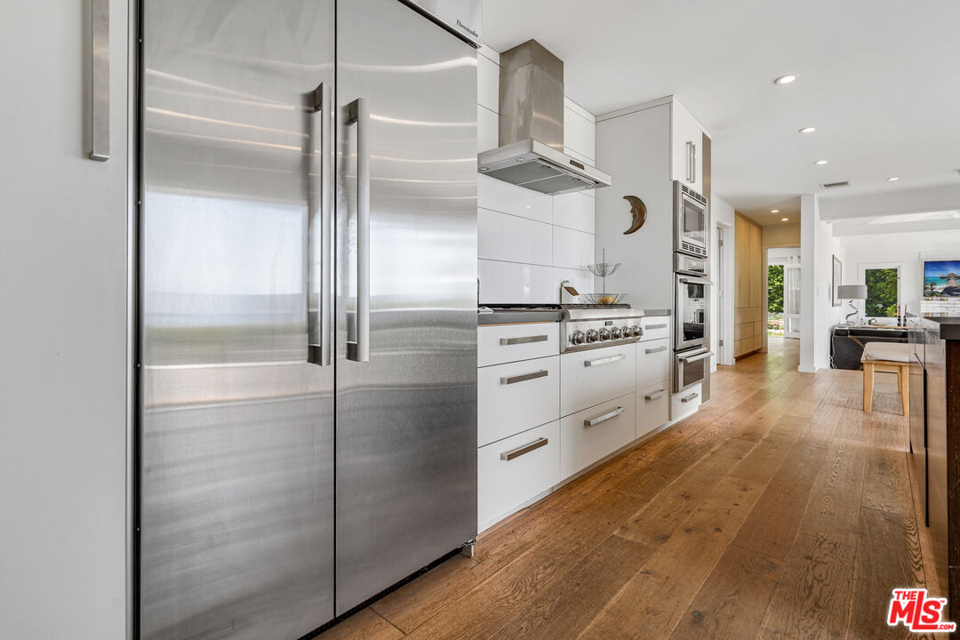 27861 Winding Way Malibu, CA 90265 - Photo 8 of 36 a kitchen with stainless steel appliances kitchen island granite countertop a refrigerator and a stove