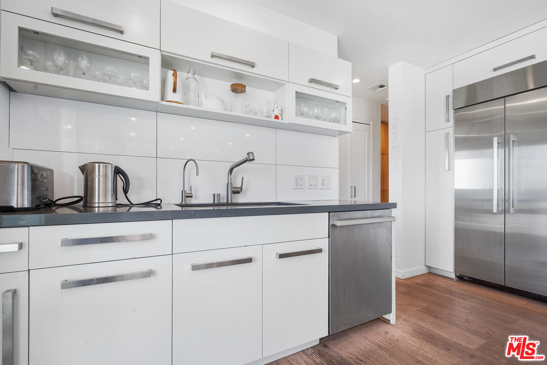 27861 Winding Way Malibu, CA 90265 - Photo 9 of 36 a kitchen with white cabinets and a sink