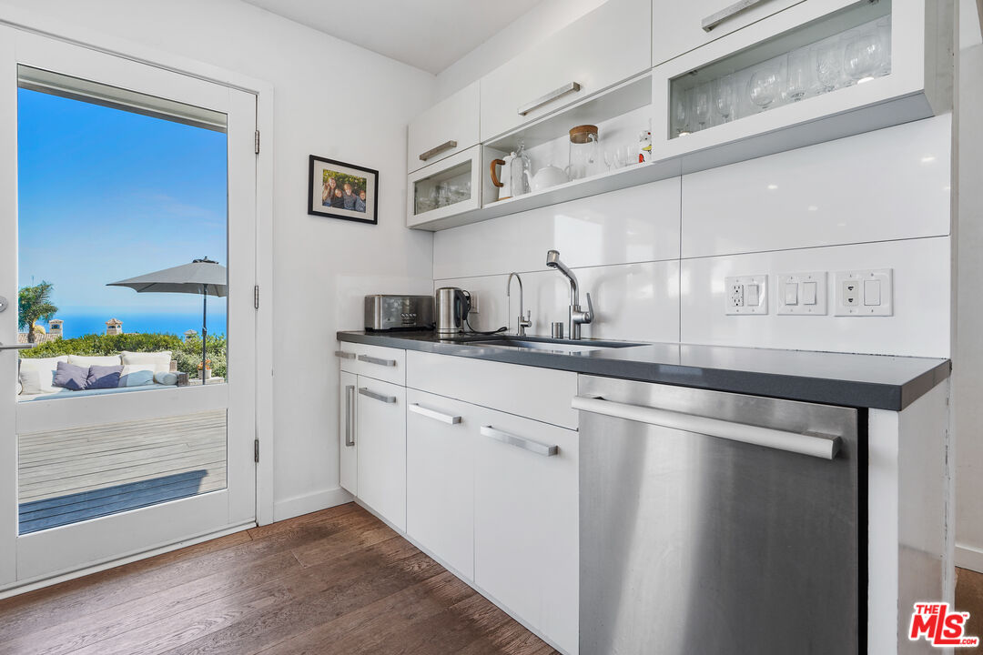 27861 Winding Way Malibu, CA 90265 - Photo 10 of 36 a kitchen with a sink and a refrigerator