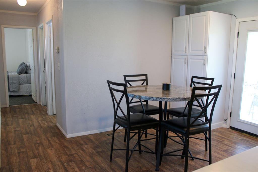 650 Lone Star Road Whitesboro, TX 76273 - Photo 5 of 18 a view of a dining room with furniture and wooden floor