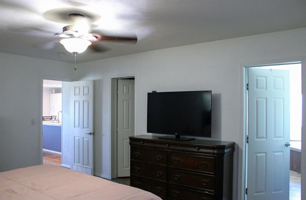 650 Lone Star Road Whitesboro, TX 76273 - Photo 7 of 18 a bedroom with a bed and a flat screen tv