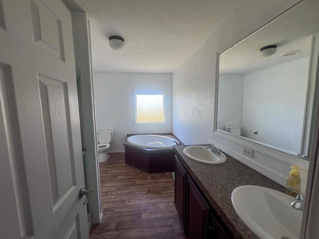 650 Lone Star Road Whitesboro, TX 76273 - Photo 8 of 18 a bathroom with a granite countertop sink and a mirror