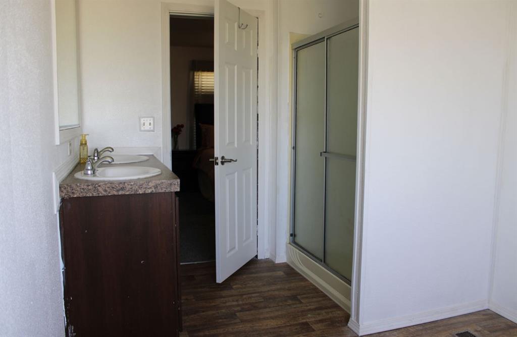 650 Lone Star Road Whitesboro, TX 76273 - Photo 9 of 18 a bathroom with a sink and a mirror