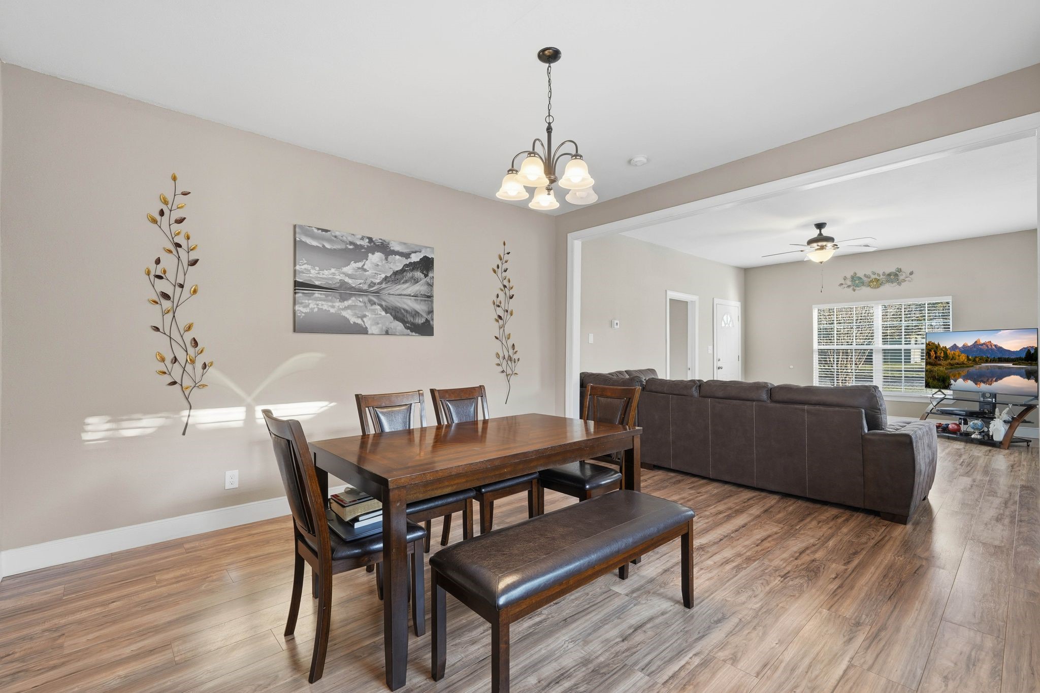 308 East Phillips Street Conroe, TX 77301 - Photo 11 of 36 a view of a dining room with furniture wooden floor and a chandelier