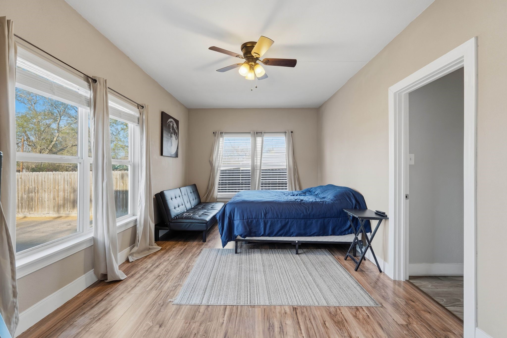 308 East Phillips Street Conroe, TX 77301 - Photo 14 of 36 a living room with a bed furniture and a large window