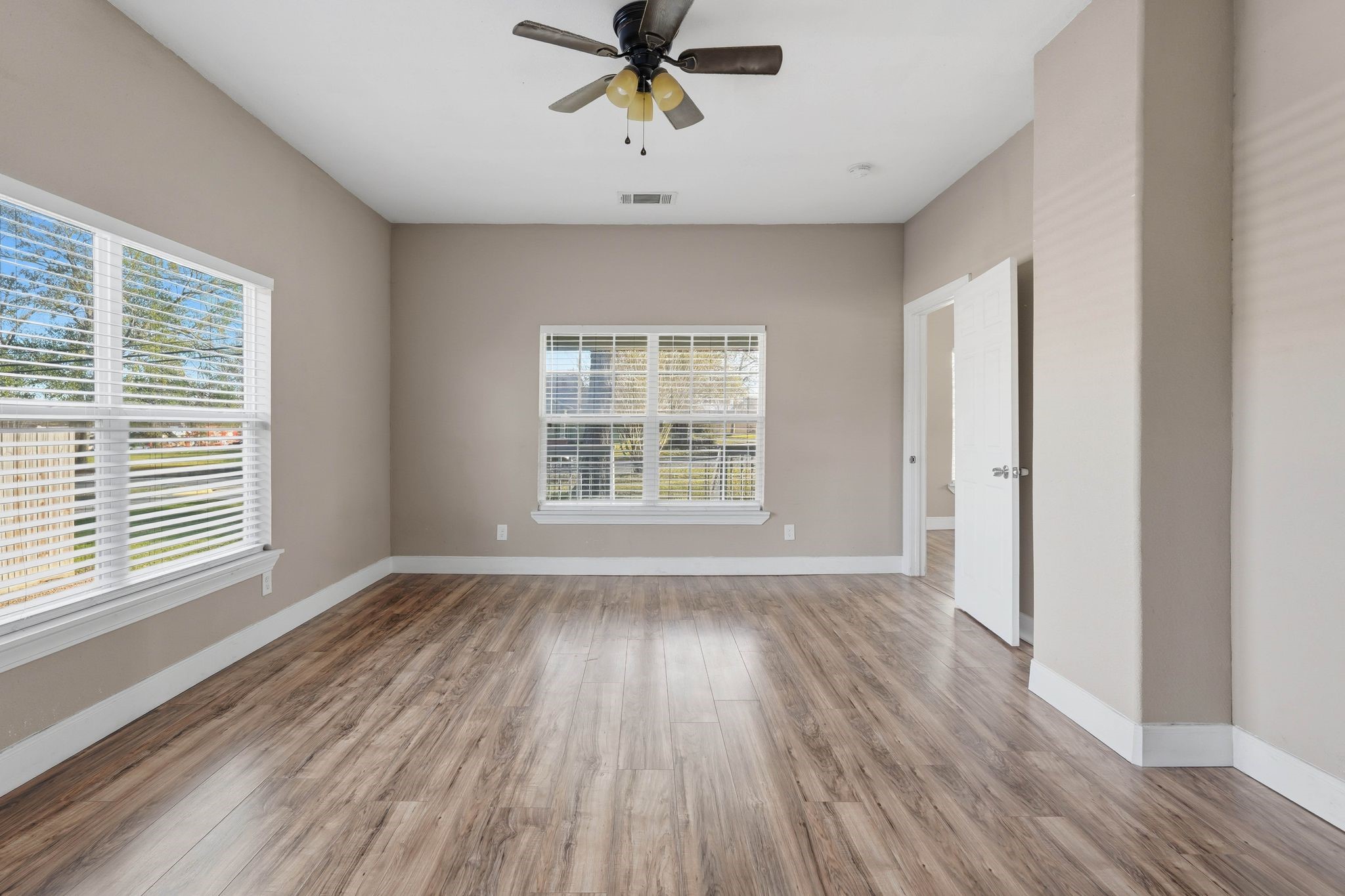 308 East Phillips Street Conroe, TX 77301 - Photo 16 of 36 a view of an empty room with wooden floor and a window