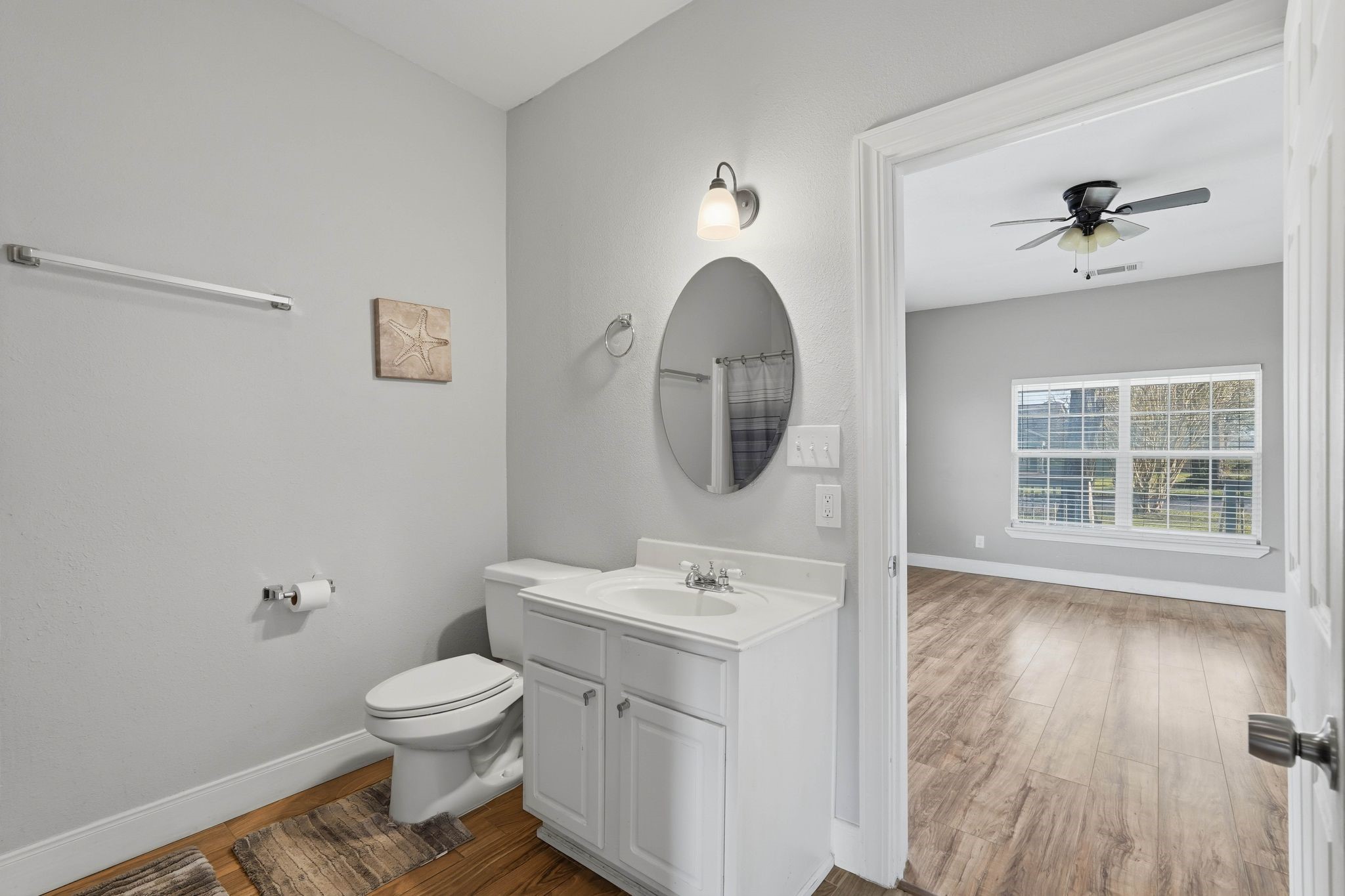 308 East Phillips Street Conroe, TX 77301 - Photo 18 of 36 a bathroom with a toilet sink and mirror