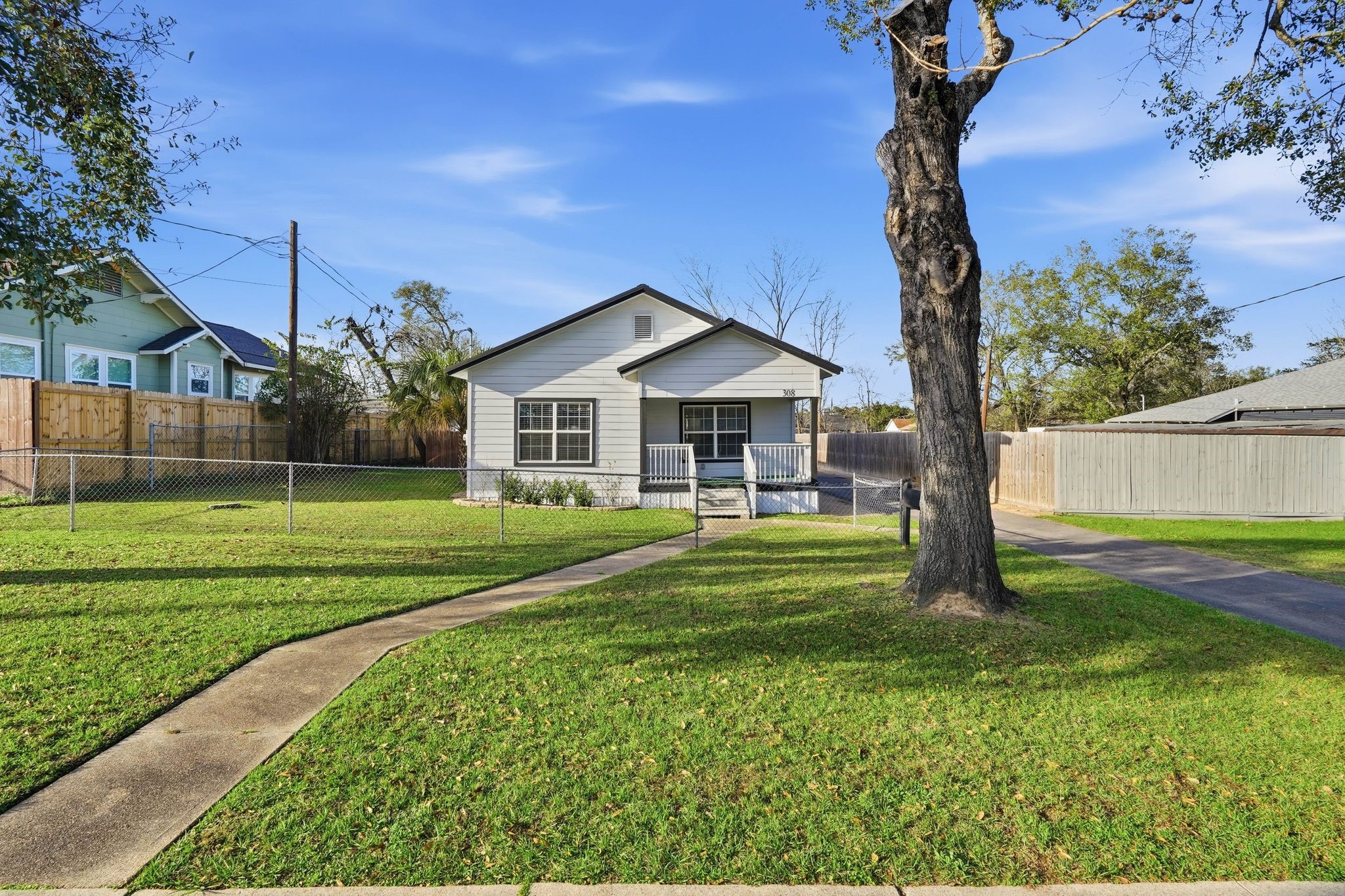 308 East Phillips Street Conroe, TX 77301 - Photo 2 of 36 a front view of a house with a yard