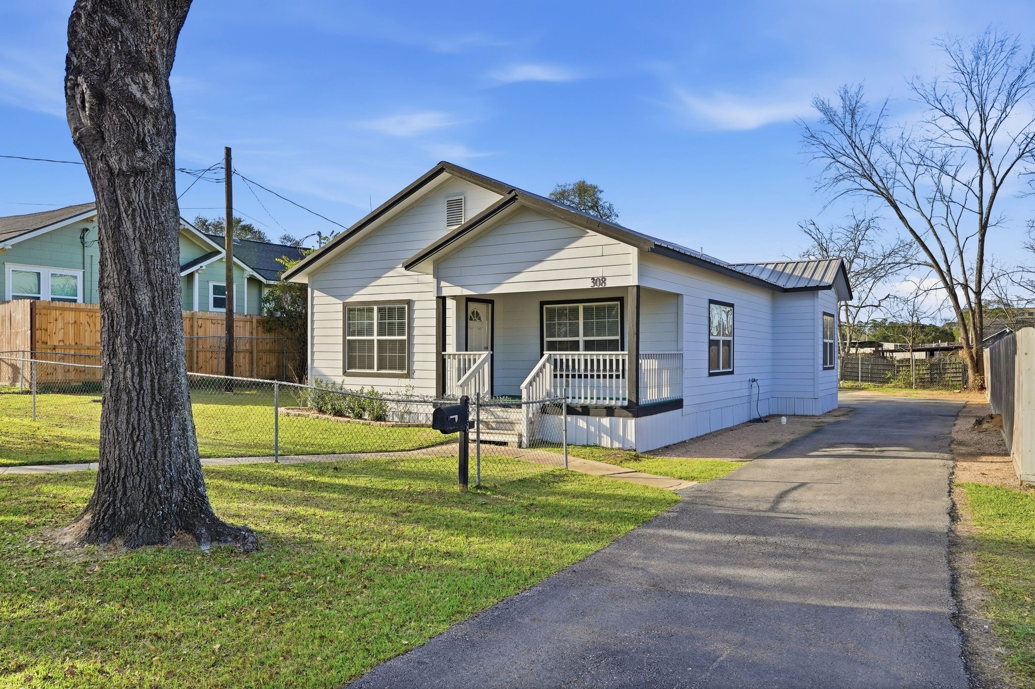 308 East Phillips Street Conroe, TX 77301 - Photo 3 of 36 a view of a house with a backyard and a tree