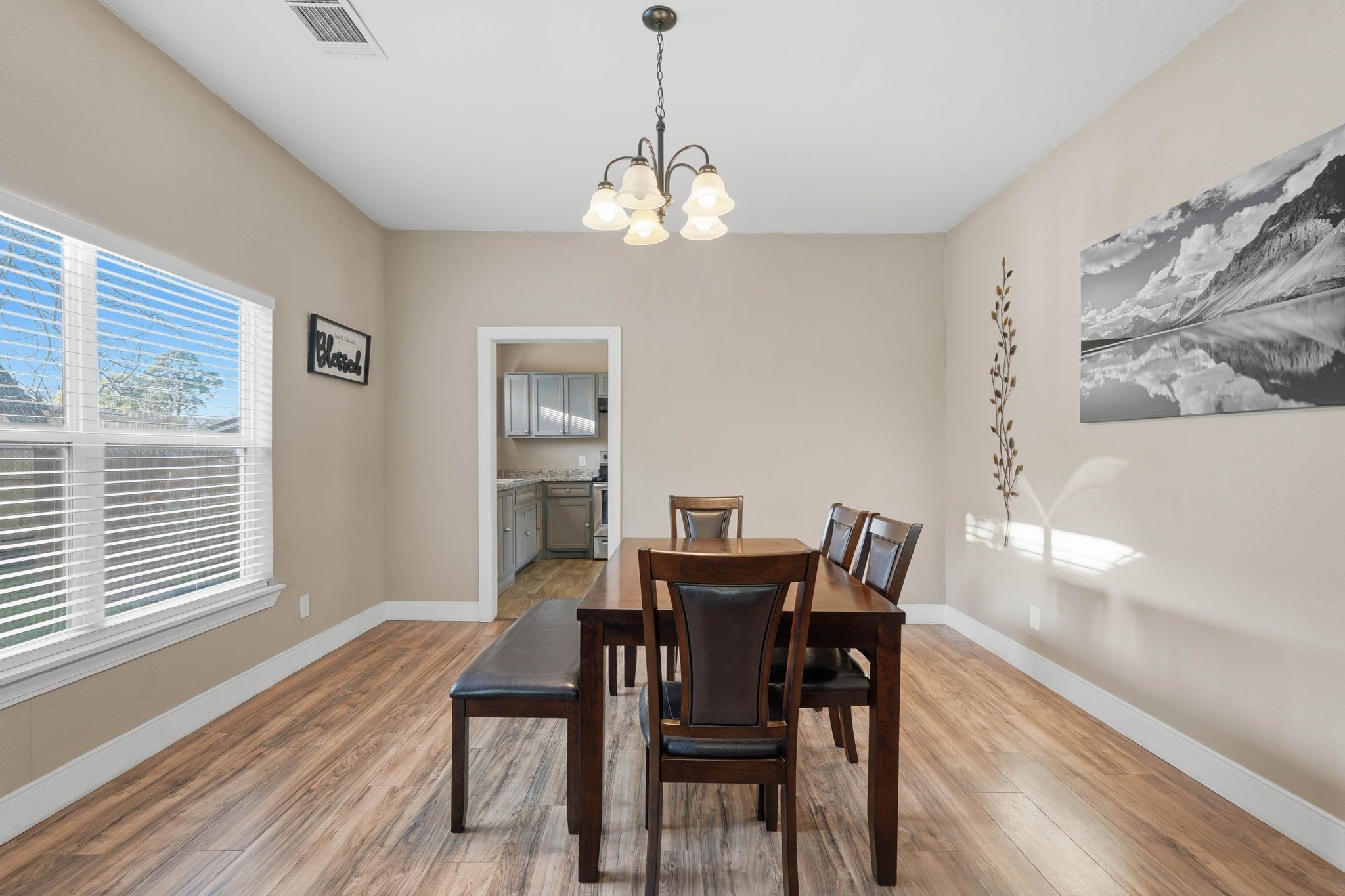 308 East Phillips Street Conroe, TX 77301 - Photo 10 of 36 a view of a dining room with furniture wooden floor and a chandelier