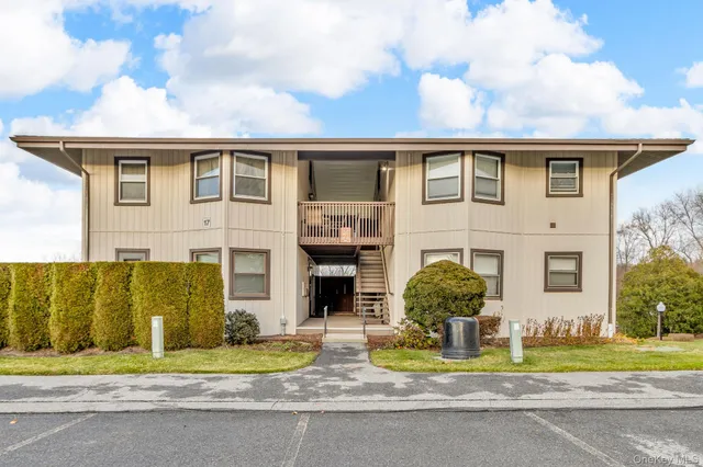 a front view of a house with a garden and plants