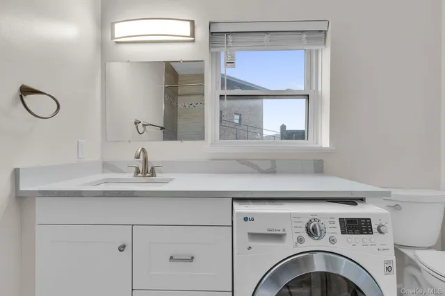 a utility room with a sink dryer and washer