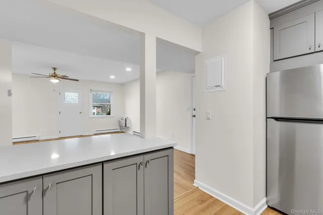 a view of a kitchen with a sink and refrigerator