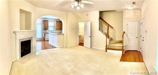 1140 Hammond Drive Matthews, NC 28104 - Photo 2 of 17 a view of a hallway with a fireplace and a chandelier