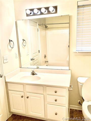 1140 Hammond Drive Matthews, NC 28104 - Photo 11 of 17 a bathroom with a sink mirror vanity and toilet