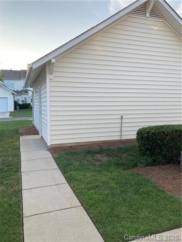 1140 Hammond Drive Matthews, NC 28104 - Photo 13 of 17 a view of a white house next to a yard