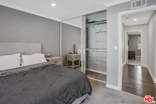 a bedroom with a bed and a view of walk in closet