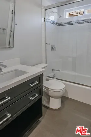a bathroom with a toilet a sink and a shower
