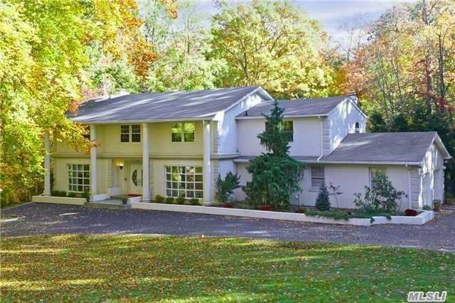 9 Forest Drive Sands Point, NY 11050 - Photo 1 of 1 a front view of a house with a garden