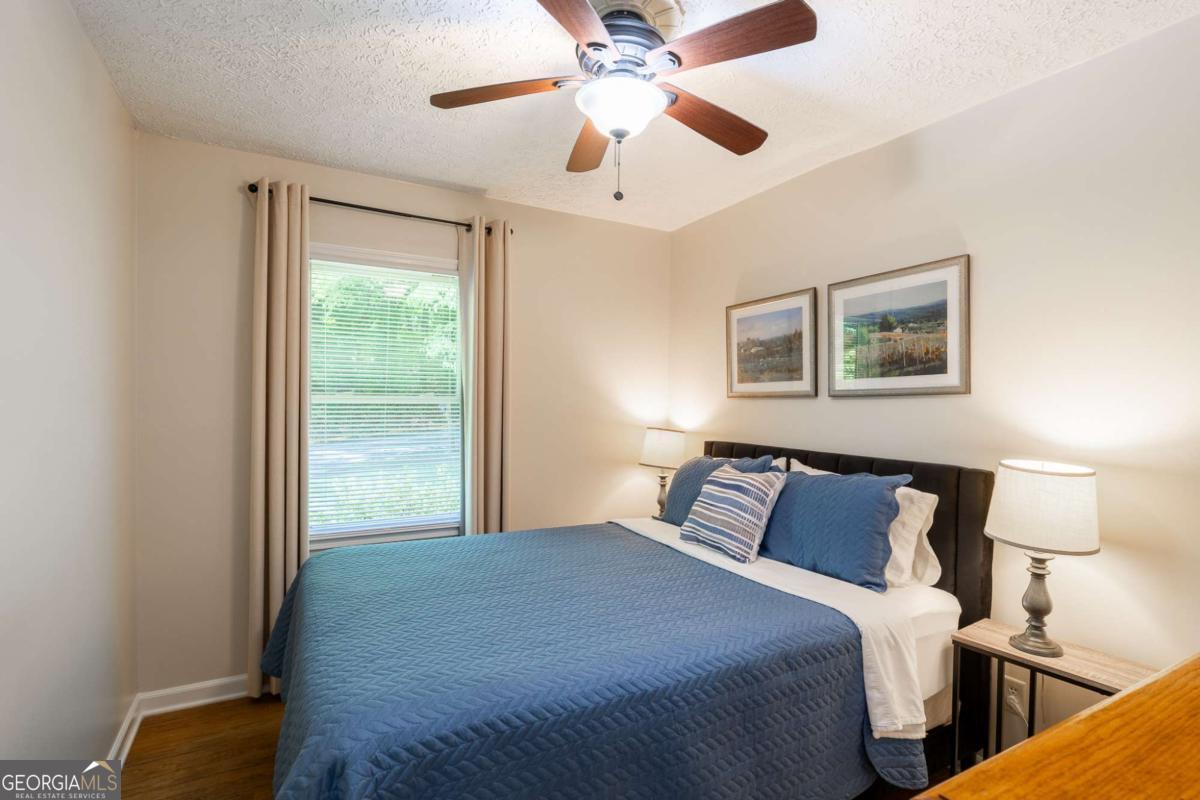 168 Pearl Street Athens, GA 30601 - Photo 16 of 43 a bedroom with a large bed and a chandelier