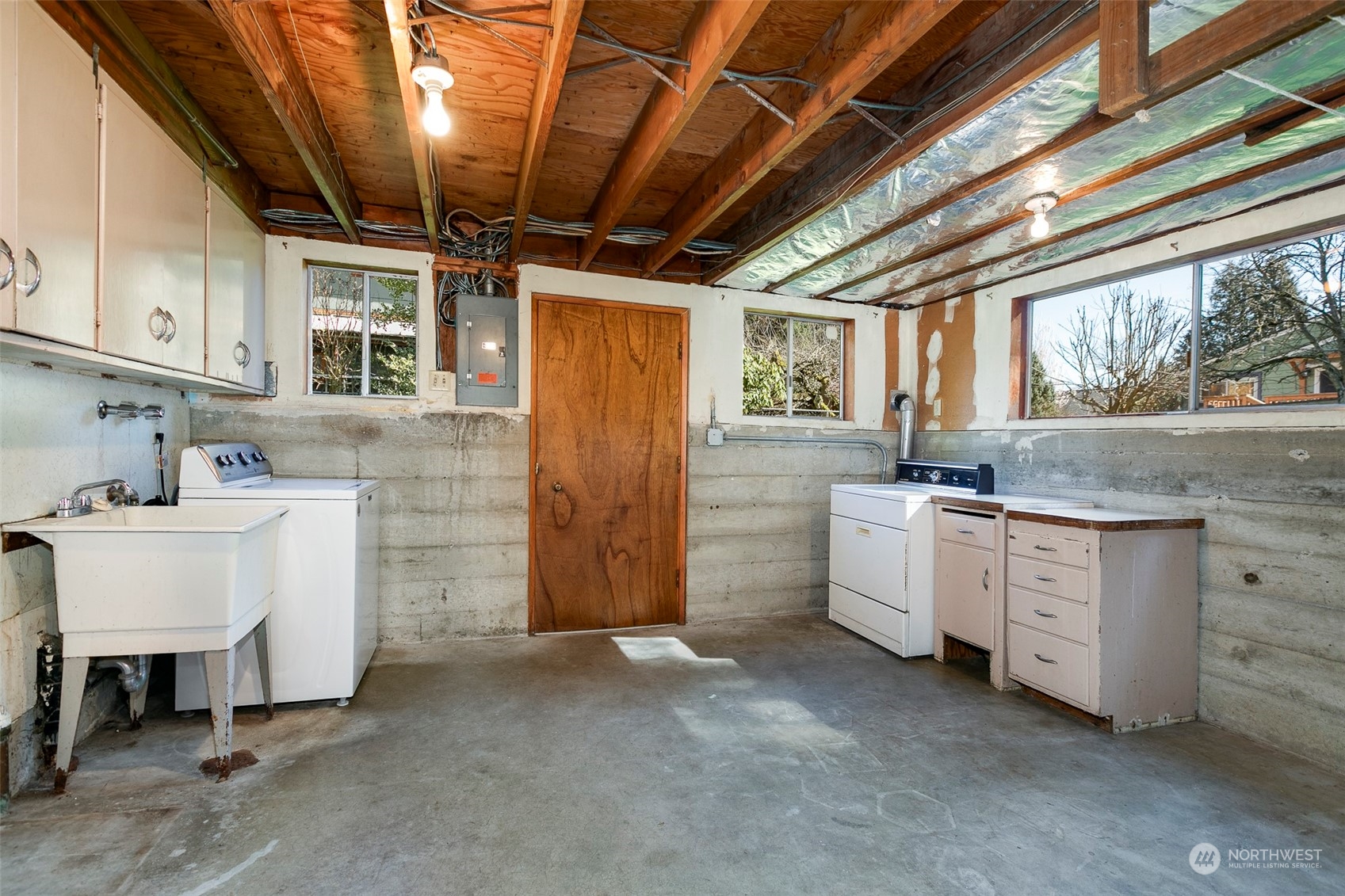 3203 Northeast 88th Street Seattle, WA 98115 - Photo 20 of 28 a utility room with cabinets dryer and washer