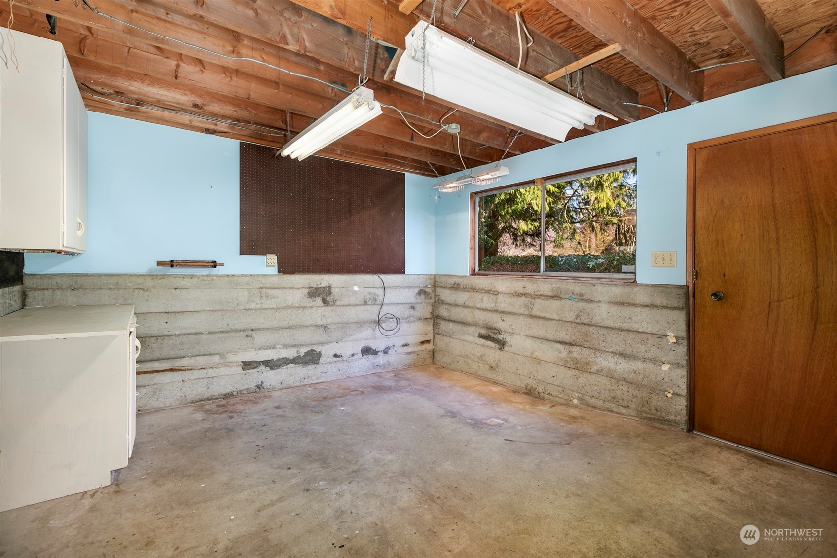 3203 Northeast 88th Street Seattle, WA 98115 - Photo 21 of 28 a view of room with wooden floor and cabinet