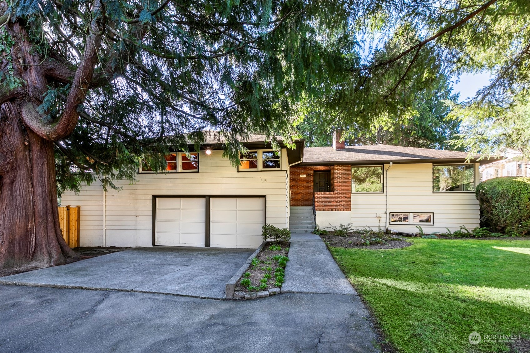 3203 Northeast 88th Street Seattle, WA 98115 - Photo 27 of 28 a front view of a house with a yard and trees