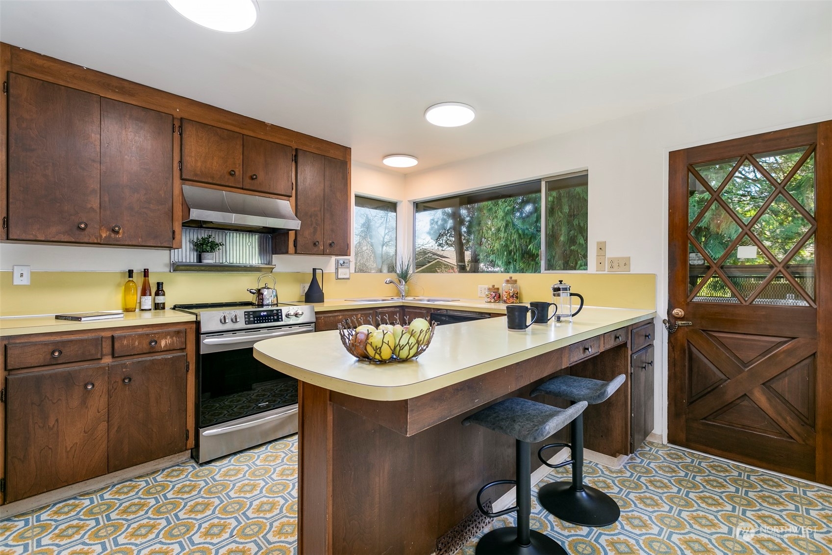 3203 Northeast 88th Street Seattle, WA 98115 - Photo 6 of 28 a kitchen with a stove a sink and a refrigerator